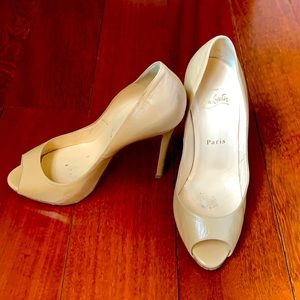 Christian Louboutin tan peep toe heels.